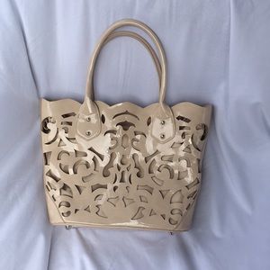 Laser cut nude handbag